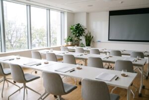 会社説明会の会場イメージ。机と椅子、資料が並んだ明るい会議室